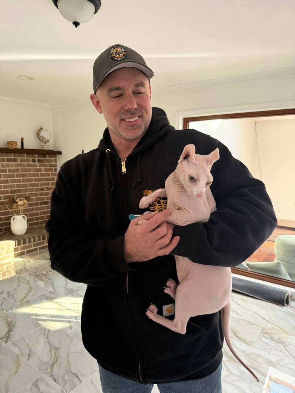 Mike with a customer's sphynx cat